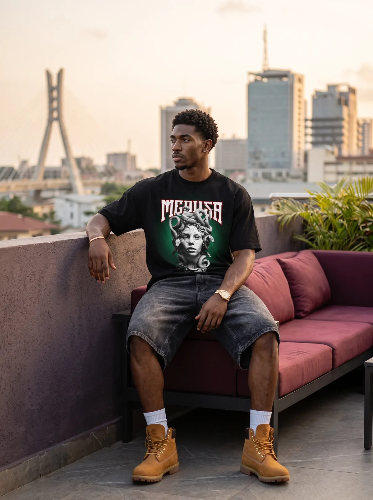 Fictional adult Black man wearing graphic streetwear in a Lagos rooftop setting