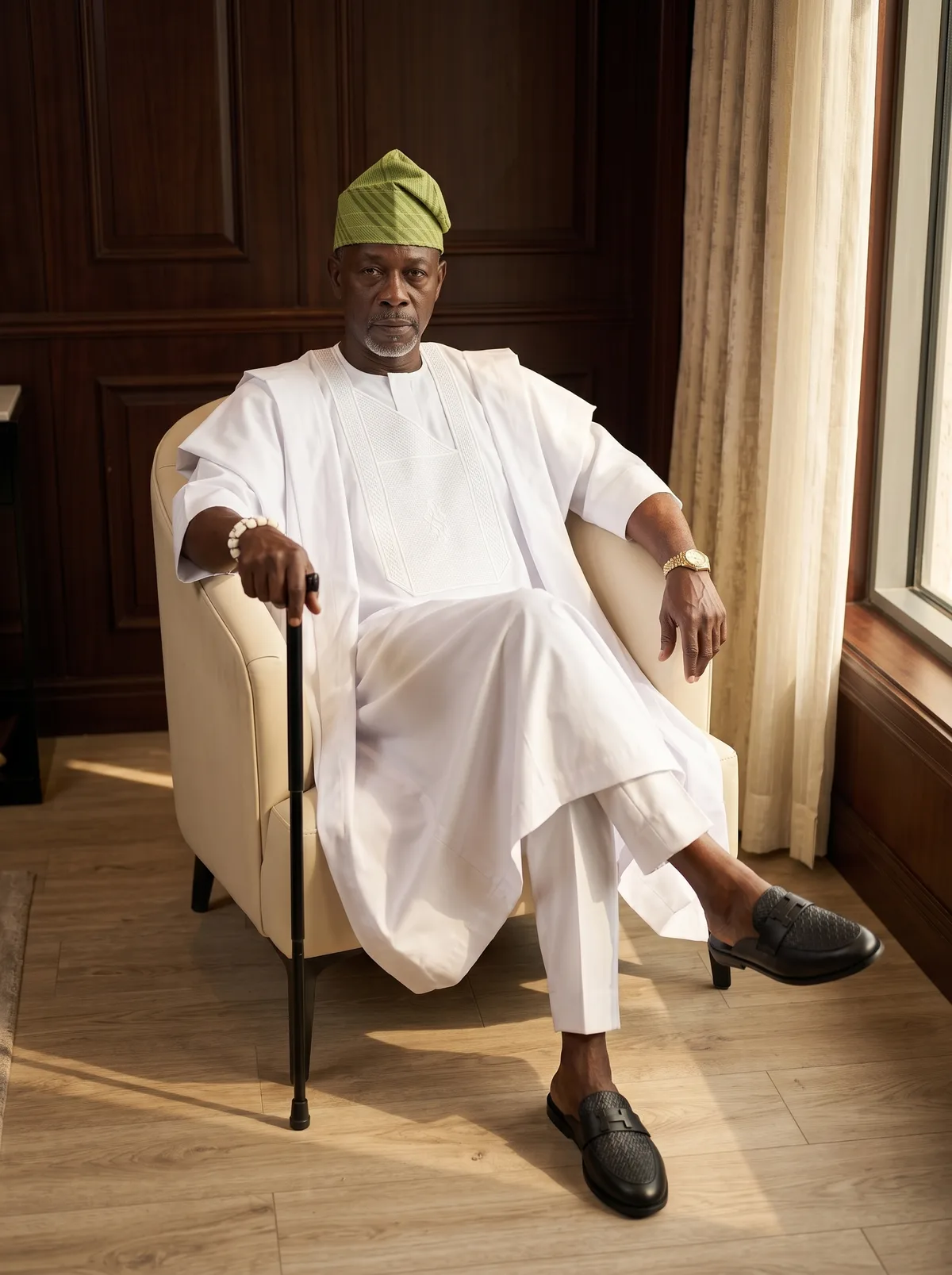 Fictional mature Black man wearing white traditional attire and a green cap in a formal portrait