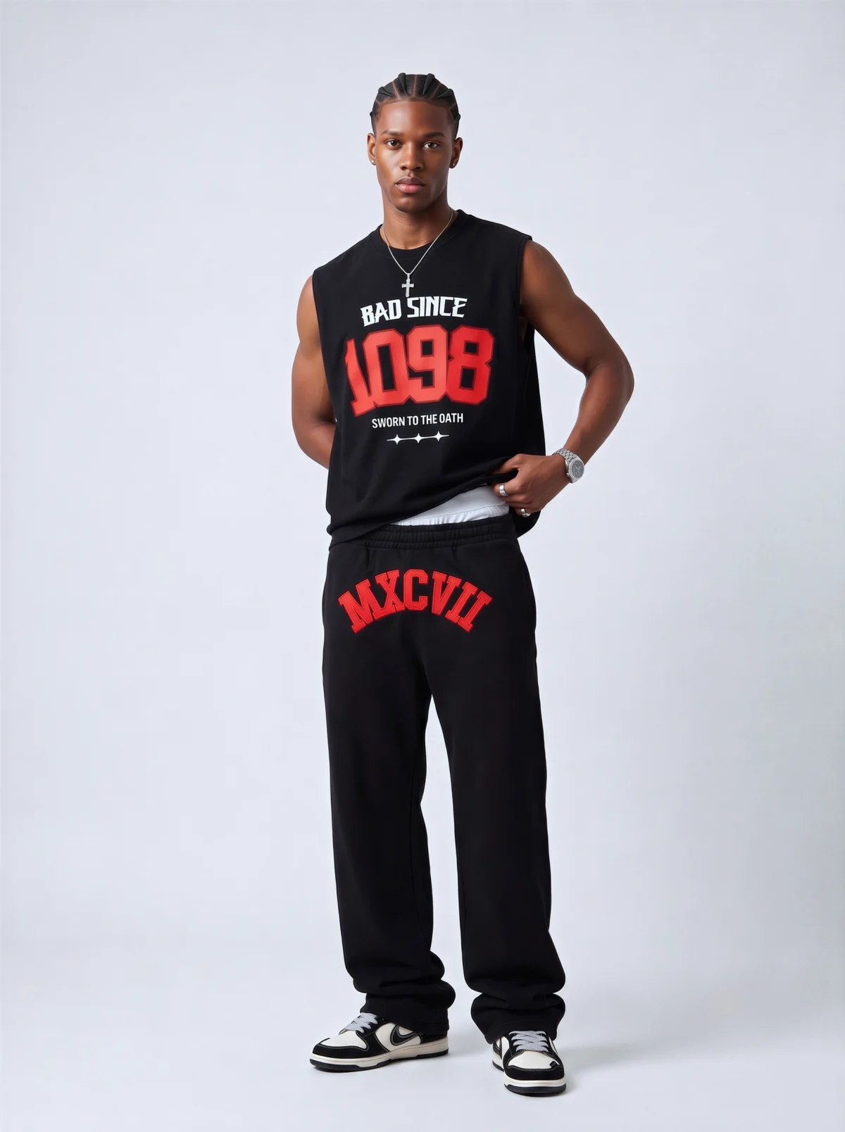 Fictional Black man modelling a black sleeveless top and matching branded sweatpants in a studio