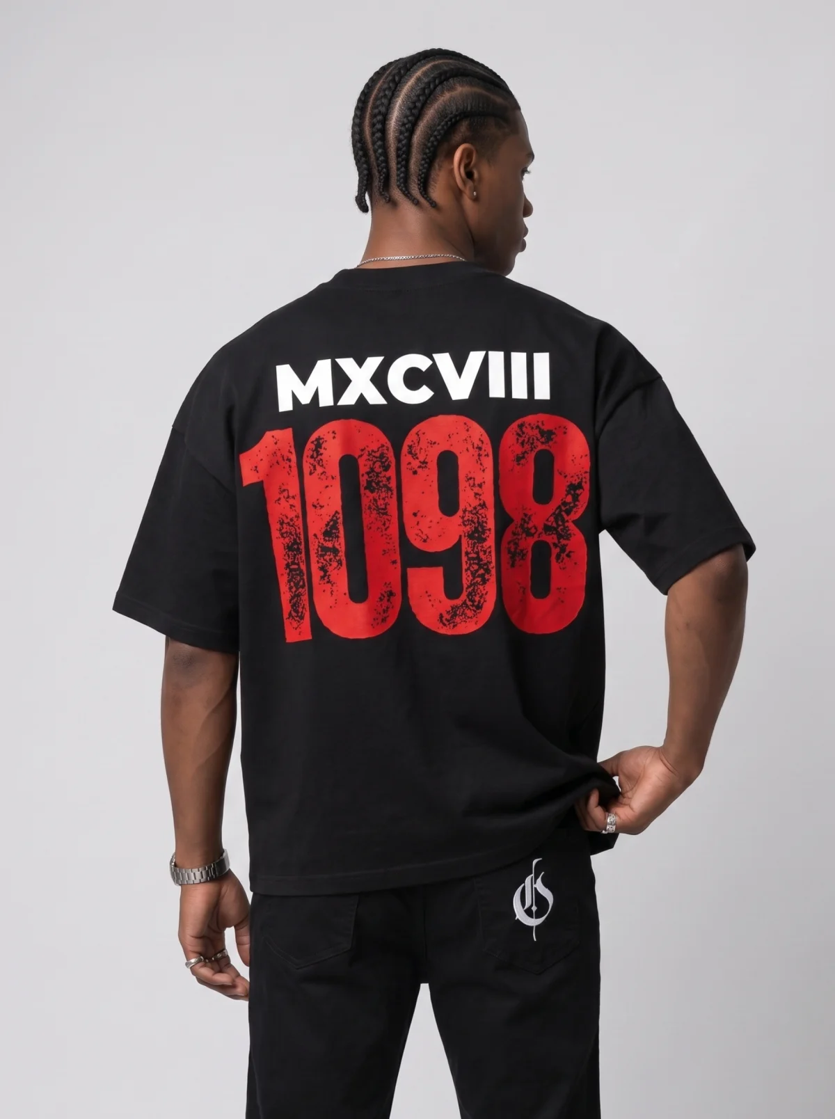 Back view of a fictional Black man modelling a black graphic T-shirt and trousers