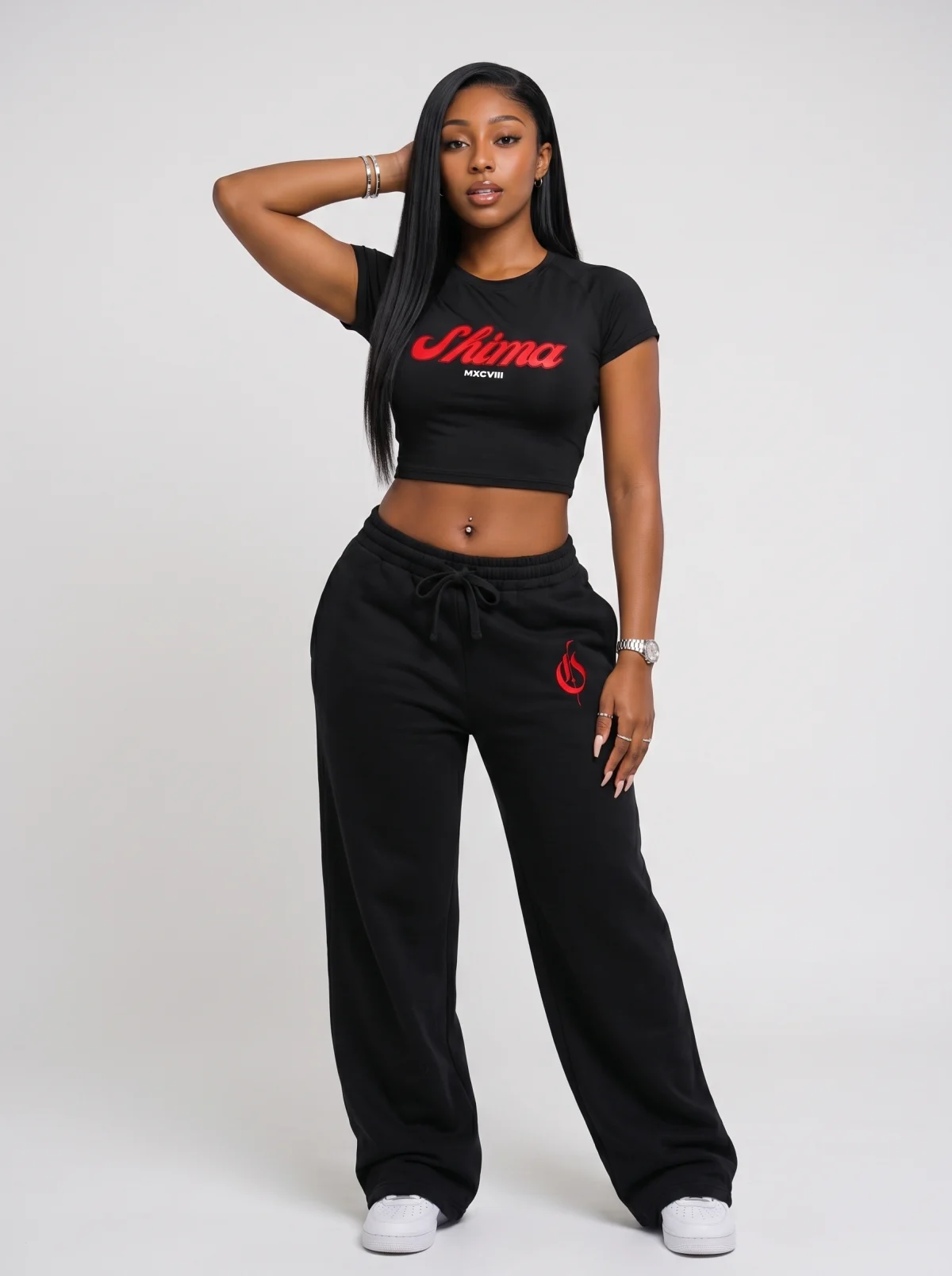 Fictional Black woman modelling a black cropped T-shirt and matching branded sweatpants